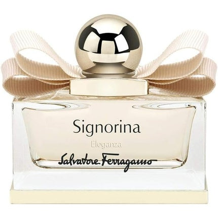 Salvatore Ferragamo Signorina Eleganza Eau de Parfum, flacon elegant cu fundal crem și fundă satinată aurie